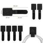 Reusable adhesive cable management straps holding desk cables